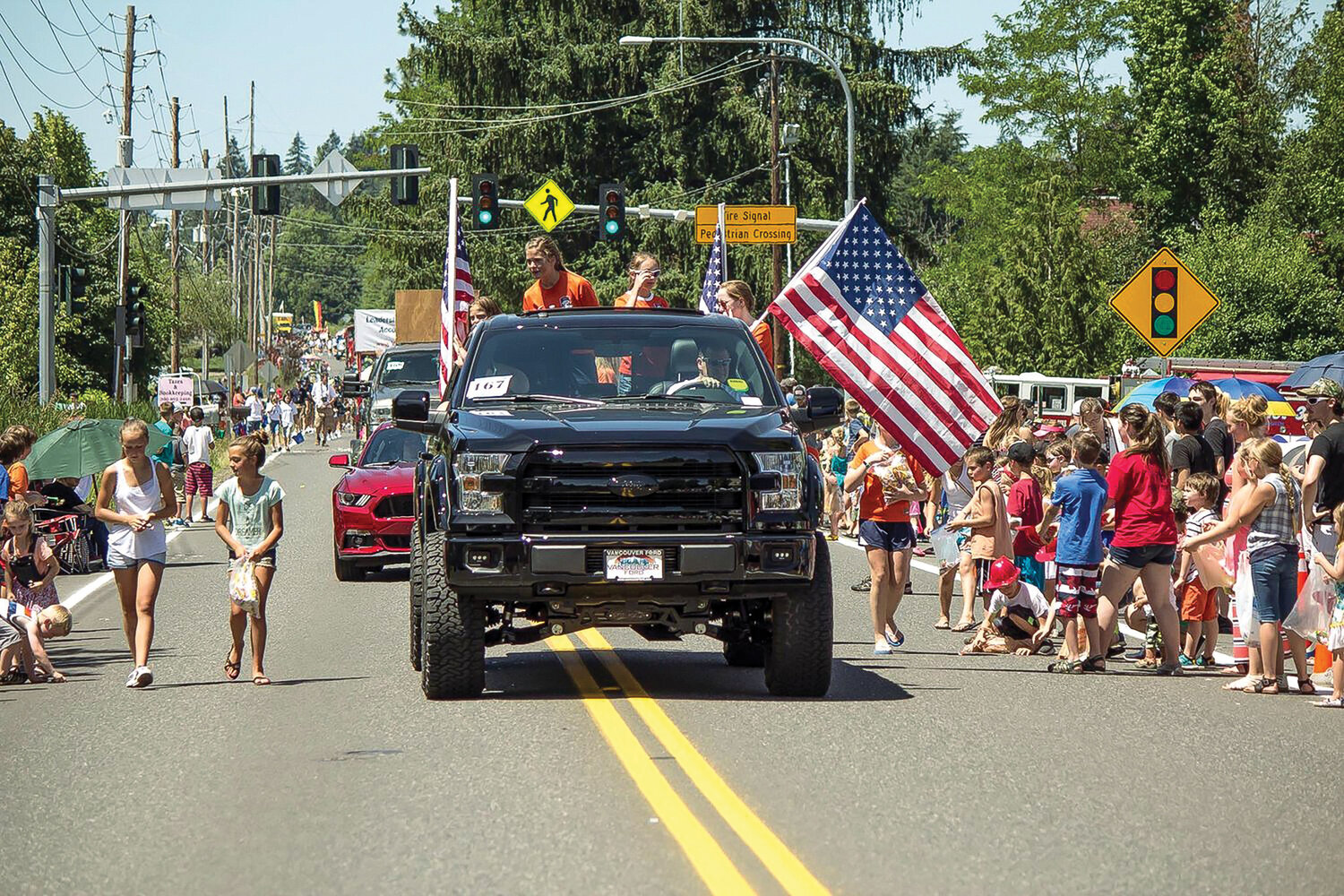 Participants in a previous Hockinson Fun Days Parade hand out candy to kids. This year’s event will take place at noon on Saturday, June 3.