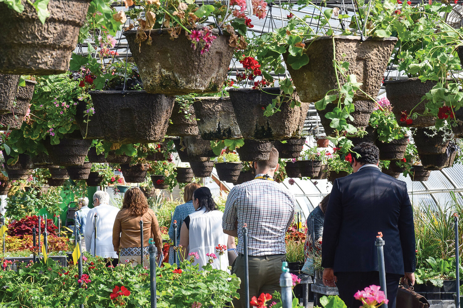 Community members at the “Discover BGPS” tour of district schools walk through Prairie High School’s greenhouse on May 25.
