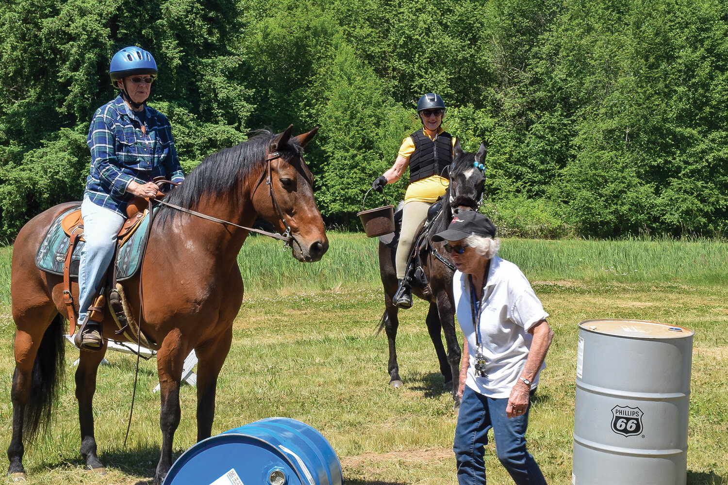 Fran Duncan heads to adjust an obstacle during the Clark County Saddle Club’s trail course event on June 3.