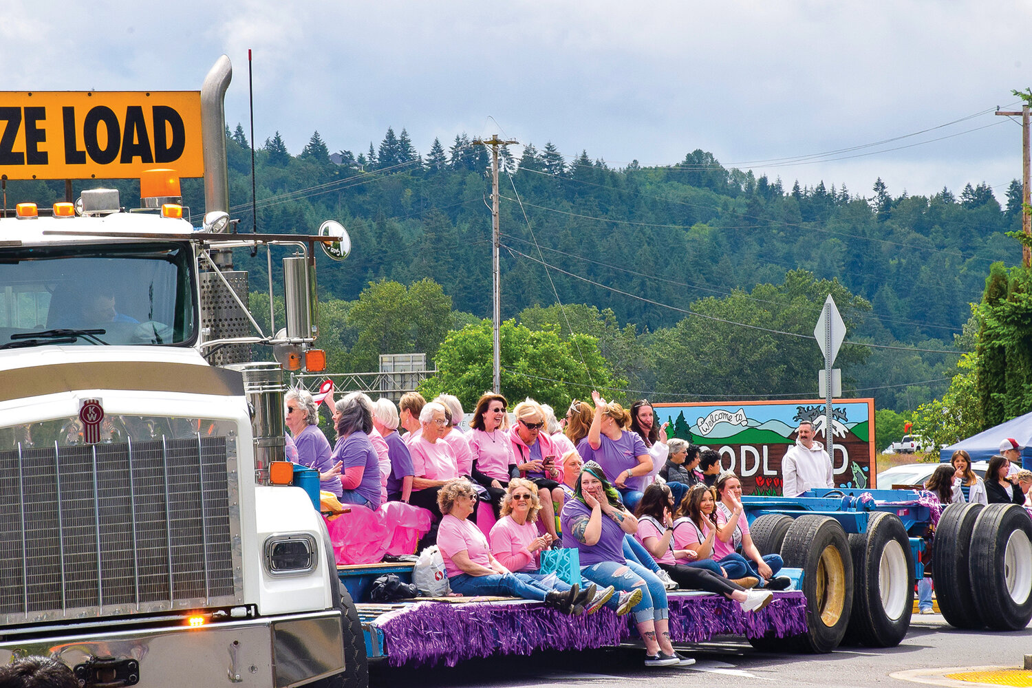 Past members of Woodland Planters Days royalty wave from the bed of a truck during the celebration’s 100th-year parade on June 18, 2022.