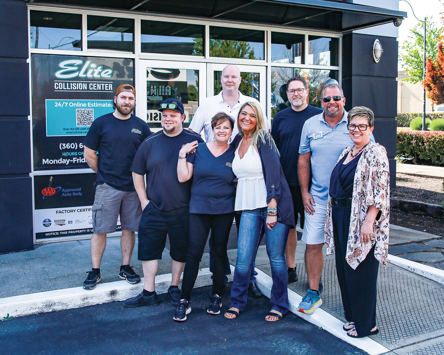 Staff members with Elite Collision Center in Battle Ground gather and pose during their 20 year anniversary celebration on Wednesday, June 7.