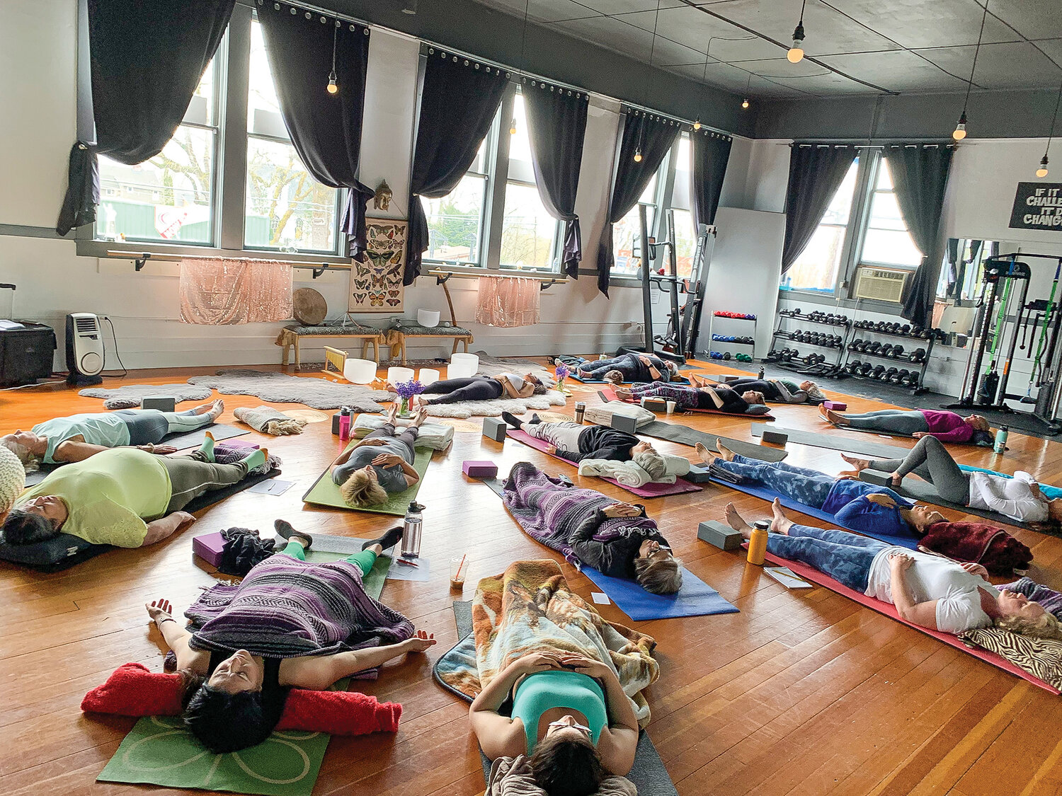 Soul Nektar co-owner and instructor Christine Kaiel, front center, teaches a yoga class at the studio in Ridgefield.