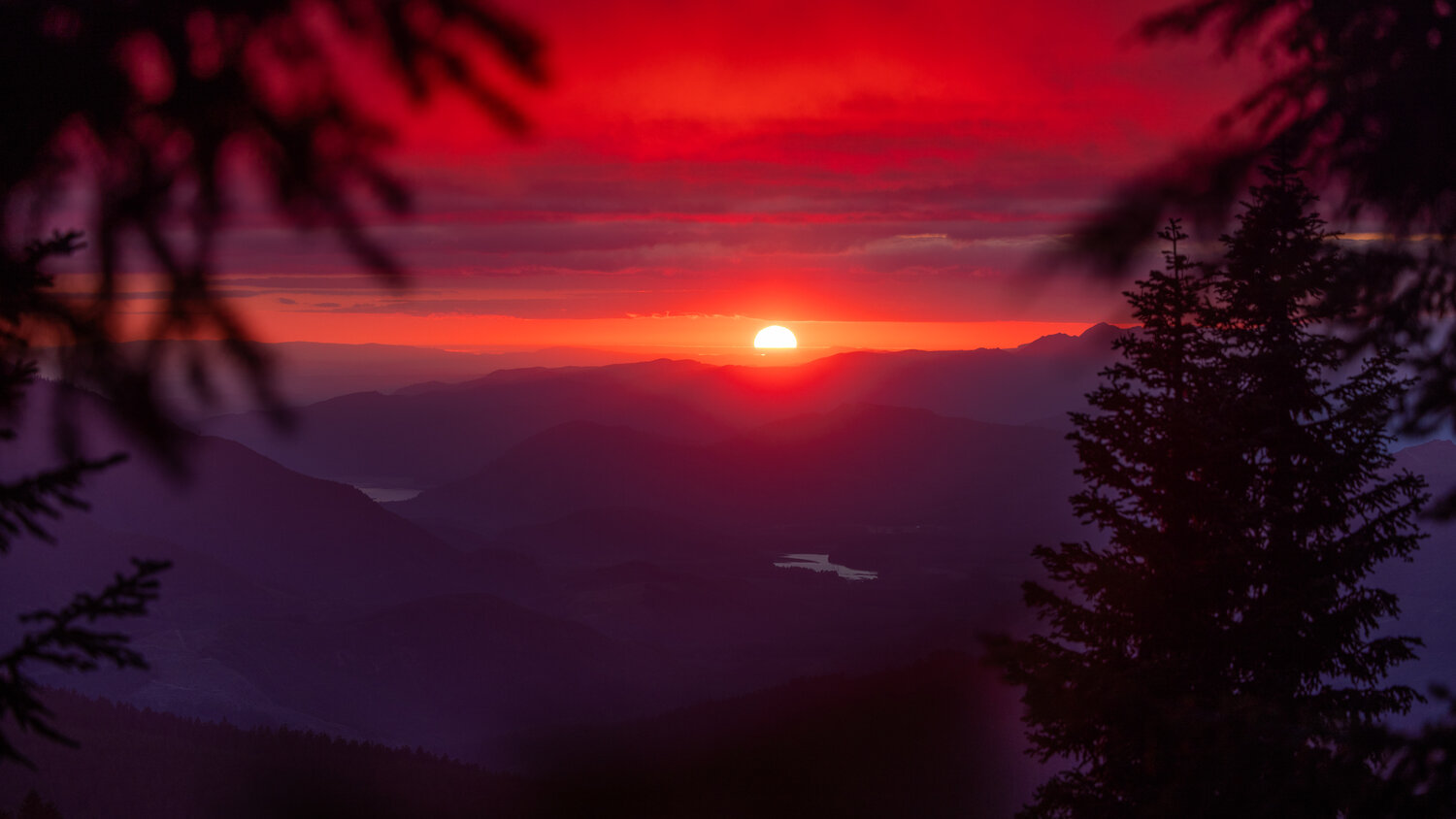 Clouds glow red as the sunset is seen from the Burley Mountain Trail on Thursday, Aug. 10, in the Gifford Pinchot National Forest.