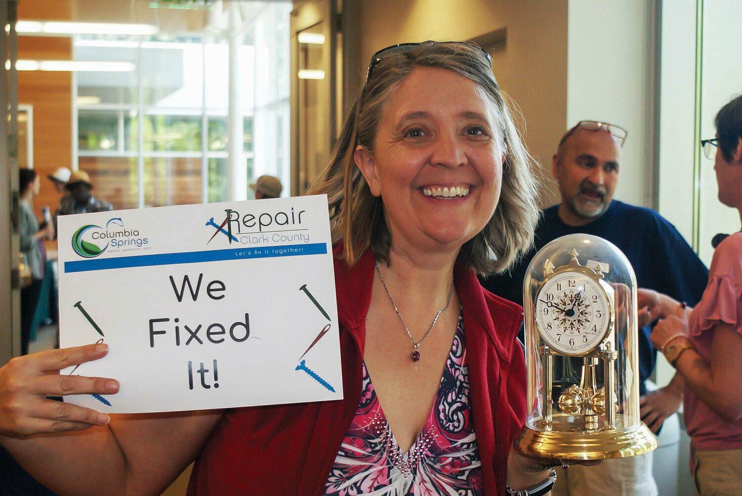 A clock is held after being fixed by Repair Clark County.