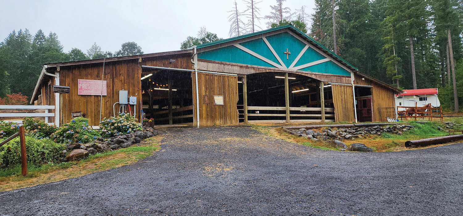 The main barn at Grace Therapeutic Horse Program contains horse stalls and a small arena.
