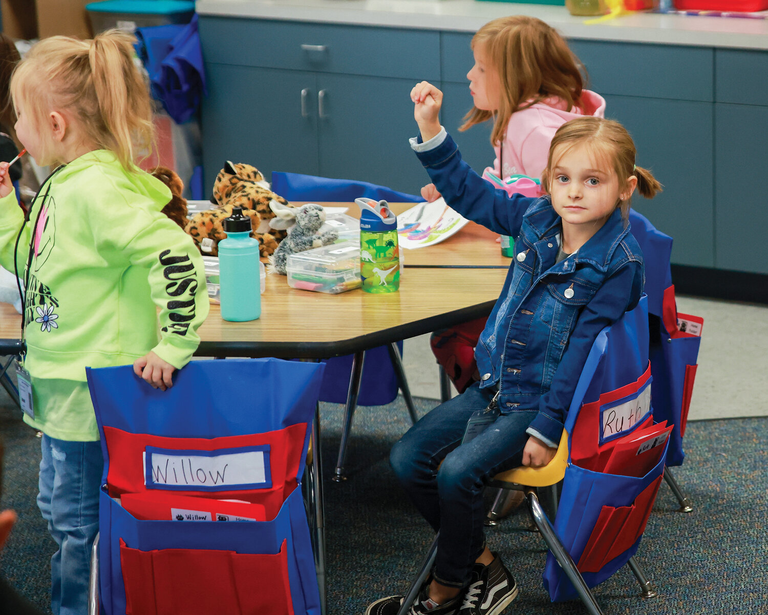 A student in Tricia Wharton’s kindergarten class at Maple Grove Primary raises their hand to ask a question during the first day of kindergarten on Tuesday, Sept. 5.