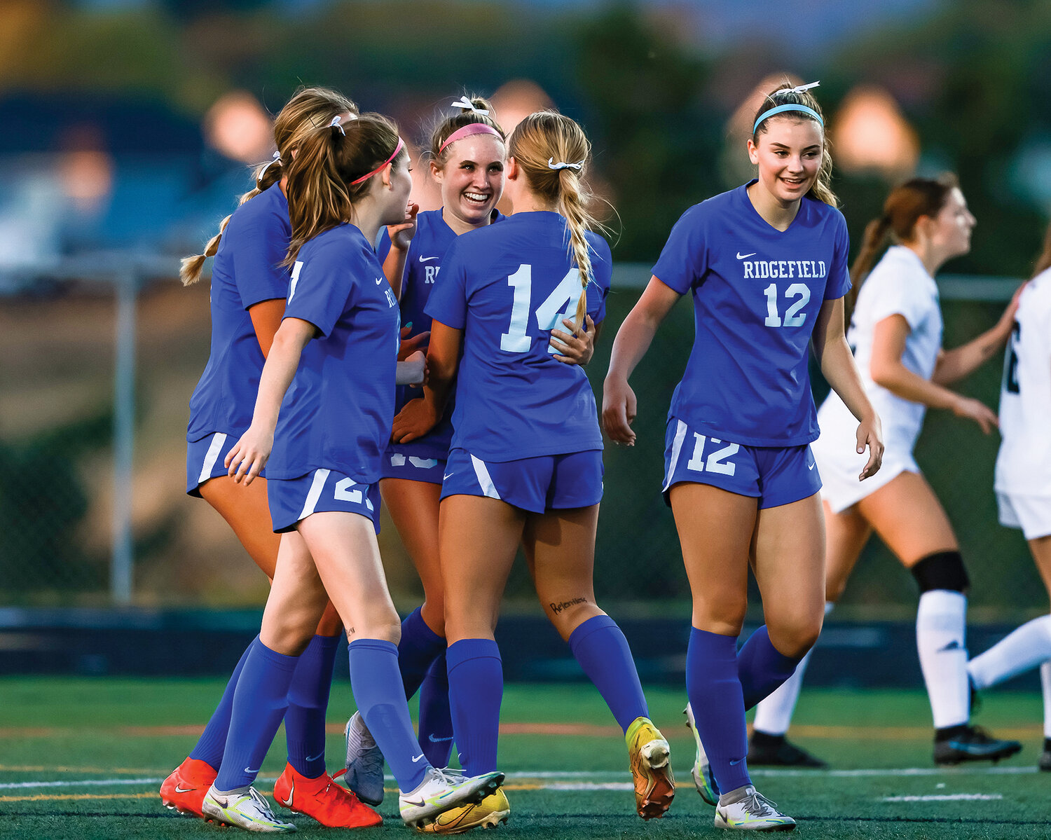 Ridgefield teammates celebrate after Victoria Lasch caused Union to commit an own-goal to take an early 1-0 lead in a 2-0 non-league victory on Thursday, Sept. 7.