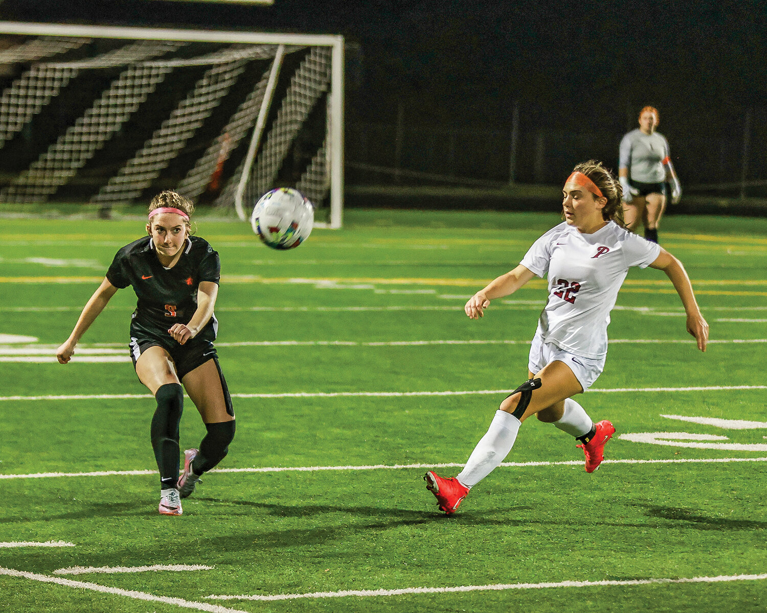 Battle Ground’s Isabella Brenes kicks the ball downfield with Prairie’s Avery Hoskins nearby on defense during the district rivals’ 0-0 draw on Tuesday, Oct. 17.