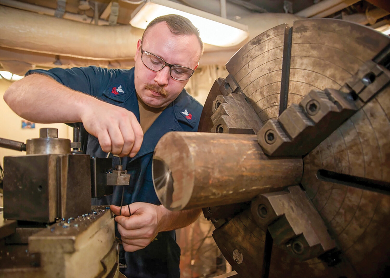 U.S. Navy Machinery Repairman 1st Class Walter Hurt, from Amboy, prepares to machine metal stock using a lathe in the machinery repair shop aboard the aircraft carrier USS Nimitz (CVN 68) while underway in the Pacific Ocean, Nov. 7. Nimitz is underway conducting routine operations.