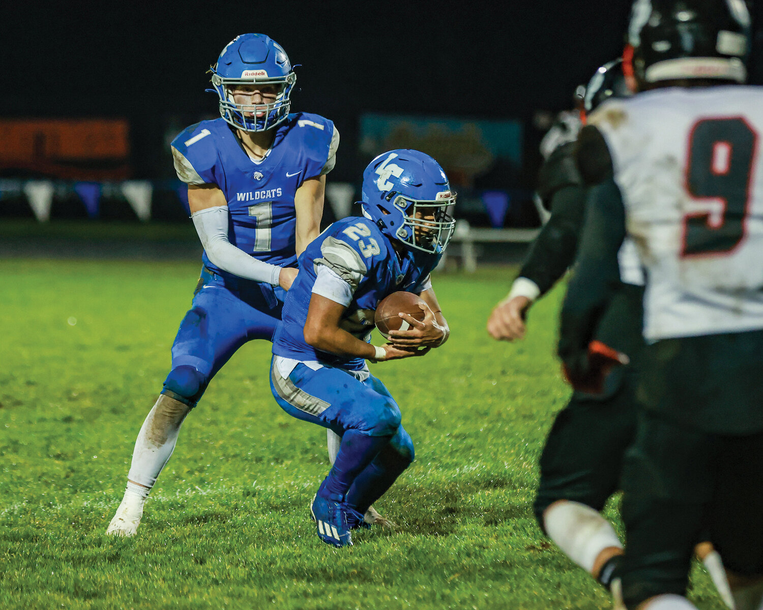 La Center’s Houston Coyle, No. 1, hands the ball off to Jalen Ward, 23, during the Wildcats’ season-ending, 21-7 loss to the Omak Pioneers on Friday, Nov. 10.