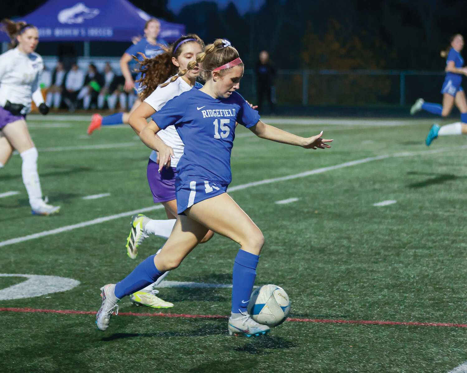 Ridgefield’s Victoria Lasch moves upfield with the ball against the Sequim Wolves in the first round of the 2A state playoffs on Wednesday, Nov. 8.