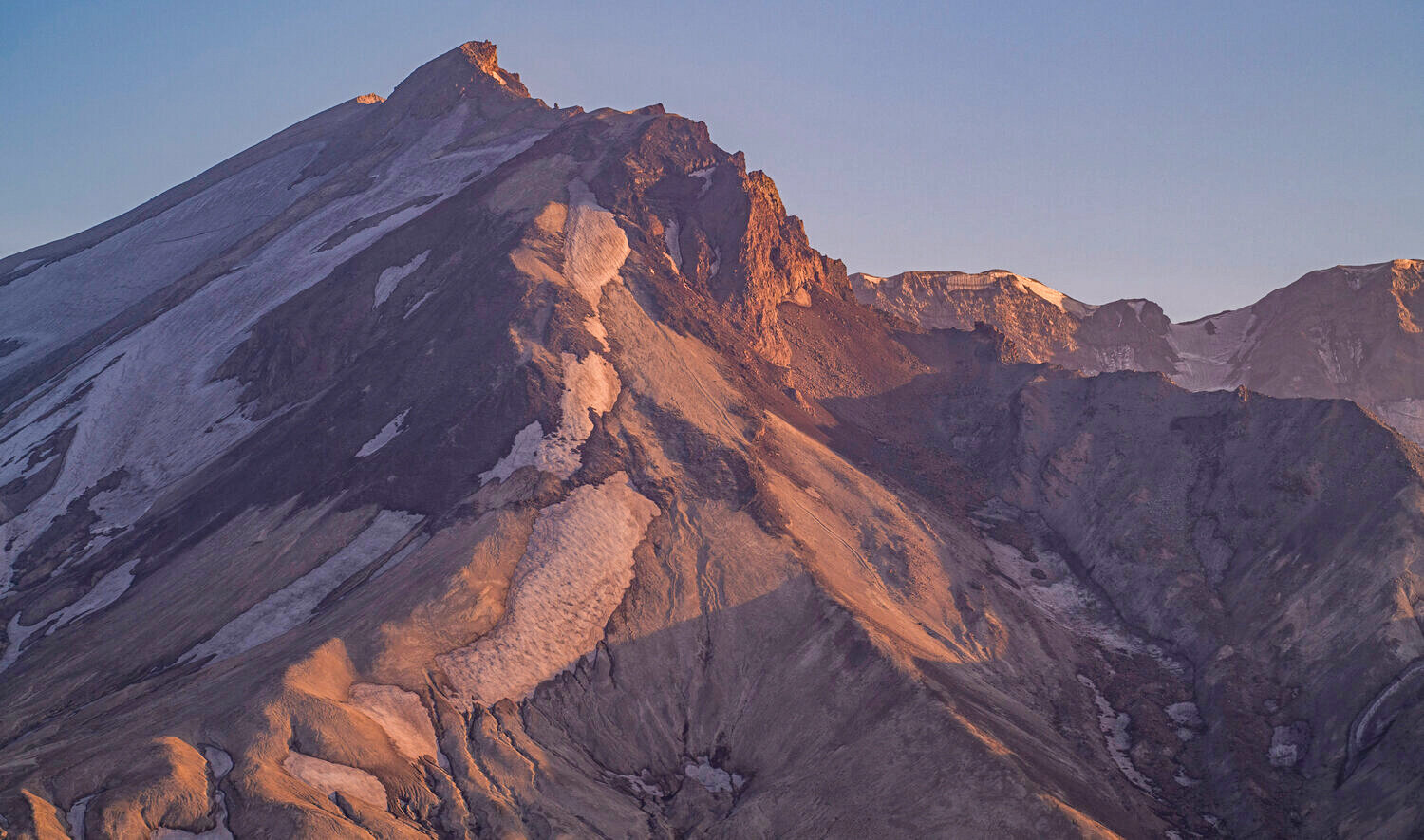 Light shines on the summit of Mount St. Helens as the sun sets on Thursday, July 6.