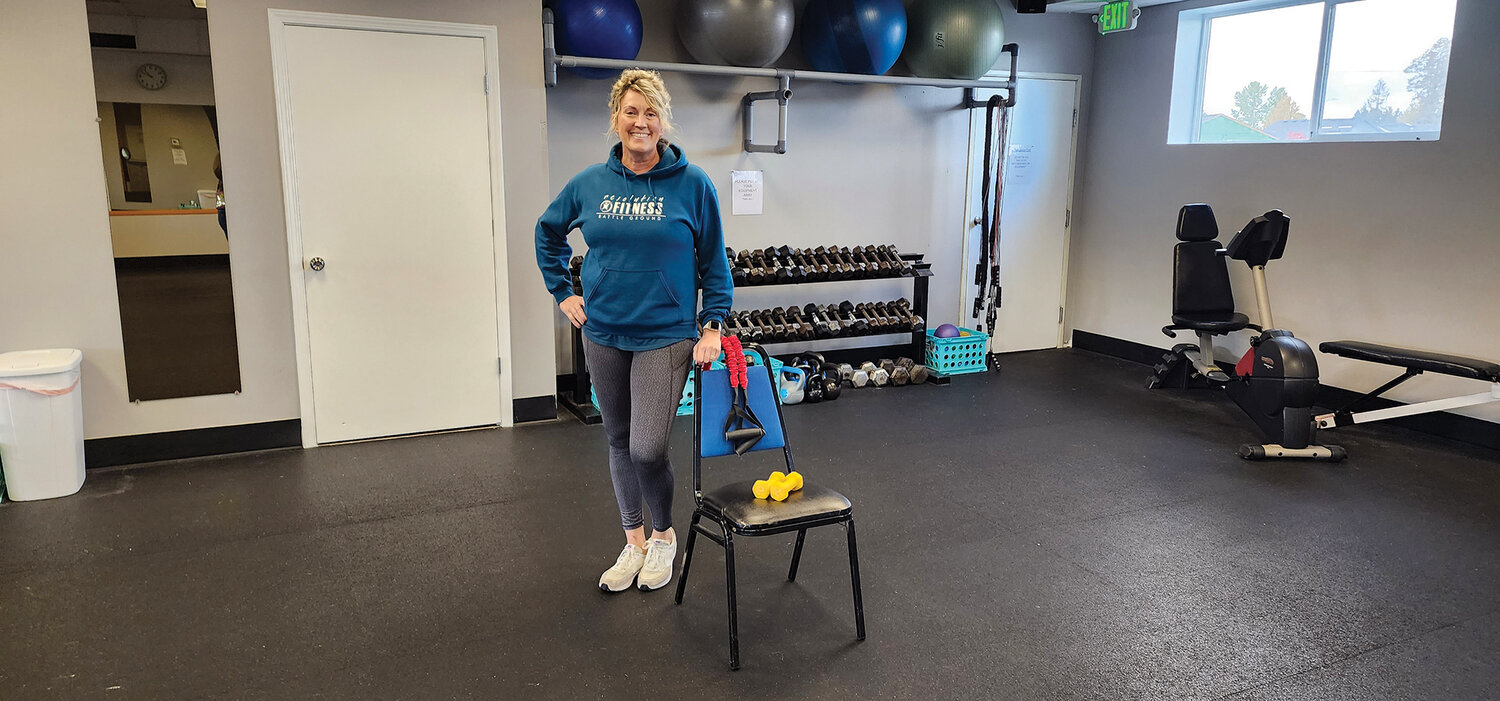 Trainer Angie Parker displays the equipment used during Silver&Fit classes: hand weights, resistance belts and a chair for extra stability.