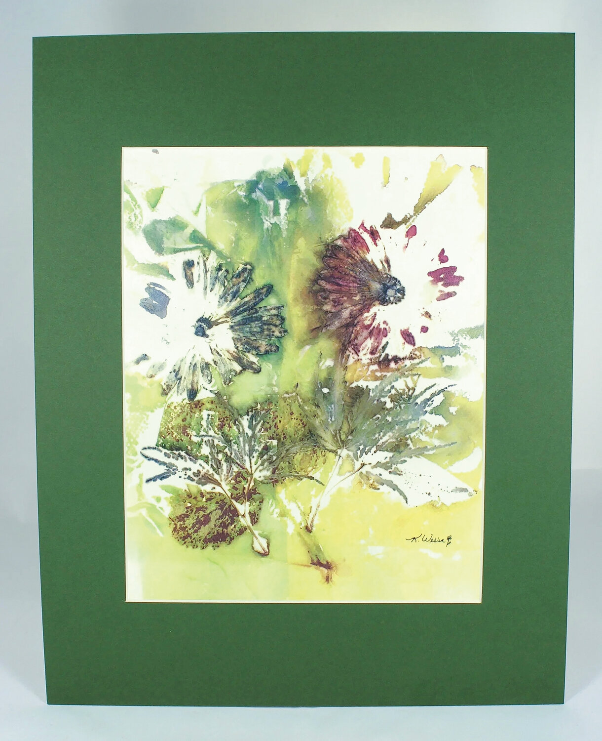 “Dancing Daylight” is an eco print artwork by Kim Wessa featuring two dahlia blooms and red maple with alum mordant.