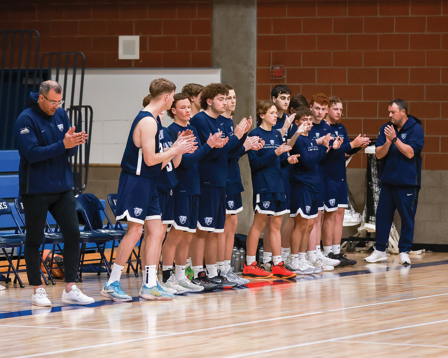 The Tenison Woods College boys basketball team from Mount Gambier, Australia, claps after the Hockinson High School band plays the Australian and American national anthems during their exhibition basketball game on Thursday, Nov. 30.